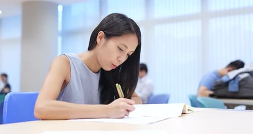 Young Woman study at university library