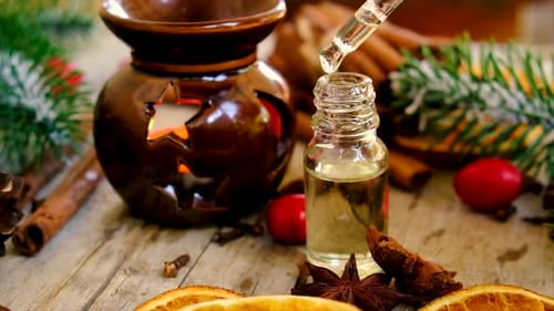 Dropping Oil for Aroma Therapy on Wooden Table