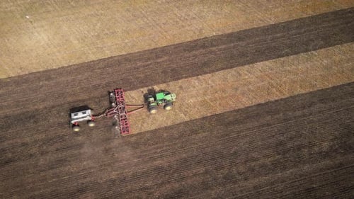 Aerial View of Tractor Tilling Soil in Rural Field