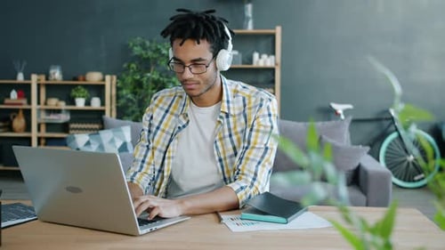 Young Adult Working on Laptop at Home