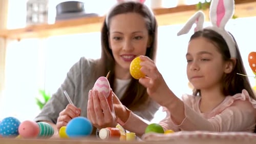 Mother and Daughter Decorating Easter Eggs Together
