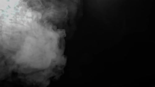 Swirling Smoke Floating Against Black Background