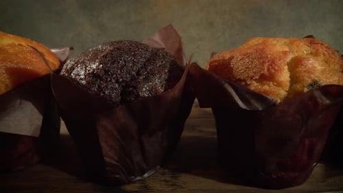 Assorted muffins displayed in brown paper wrapping