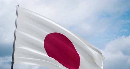 Japanese Flag Waving Against Blue Cloudy Sky