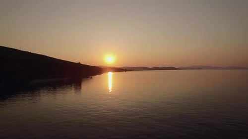 Aerial Sunset Scene of Sea and Town on Shoreline, Greece