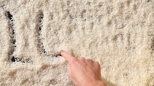 Hand Draws Rice Message with Toy Globe
