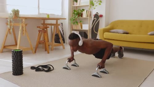 Man Doing Pushups with Parallettes Indoors