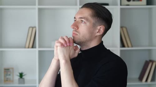 Man Praying with Hands Together in Quiet