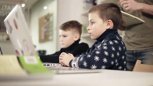 Children Working on Laptops with Adult