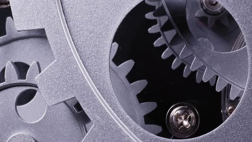 Rotating Metal Gears Interlock in Close-up