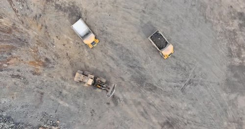 Heavy Dumpbody Truck Loaded with Limestone Ore Moves Along the Road in a Quarry