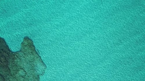 Transparent sea water near stony remote coast