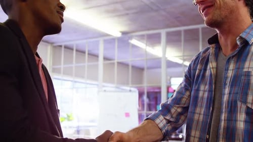 Businessmen Shaking Hands in Modern Office