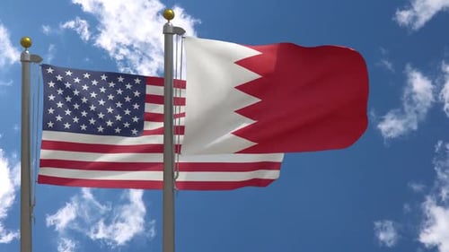 USA and Bahrain Flags Waving in Wind Against Blue Sky