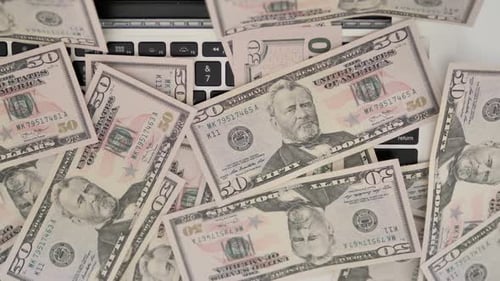 Fifty Dollar Bills on Computer Keyboard Close-Up