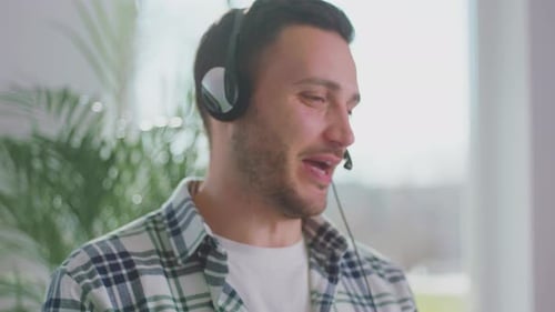 Smiling Man Talking on Headphones with Microphone