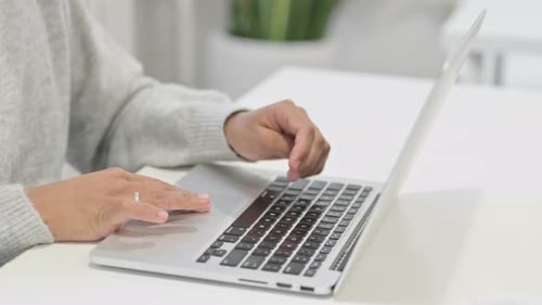Close Up of Hands of African Woman Working on Laptop
