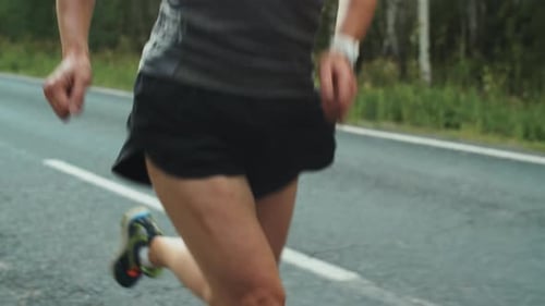 Woman Jogging on Rural Road in Sunlight