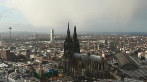Slide and Pan Aerial Footage of Historic Gothic Cathedral with Decorated Tall Towers