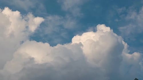 Clouds Drifting Across Bright Blue Sky