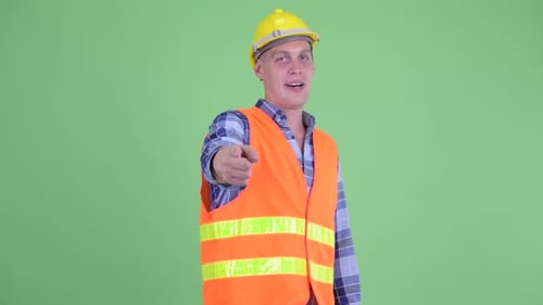 Construction Worker Pointing and Giving Thumbs Up