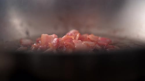 Bacon Sizzling in a Pan with Garlic