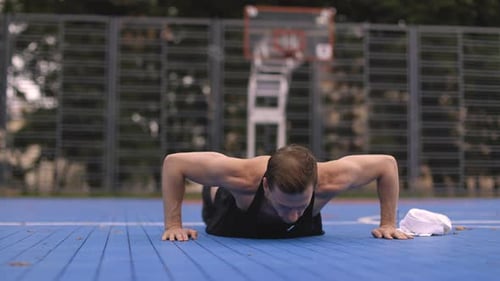 Man Does Pushups on Outdoor Court