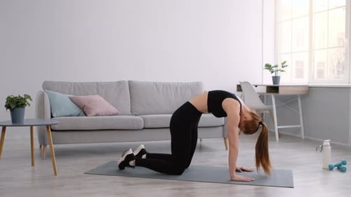 Woman Does Cat Cow Stretch Exercise Indoors