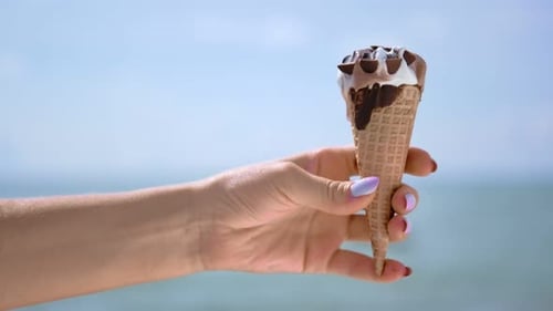 Ice Cream Cone Melting on a Sunny Beach