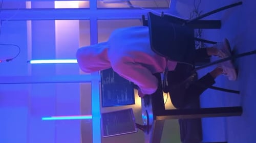 Hacker Working Place: Hacker Working in a Room with Colored Neon Lights