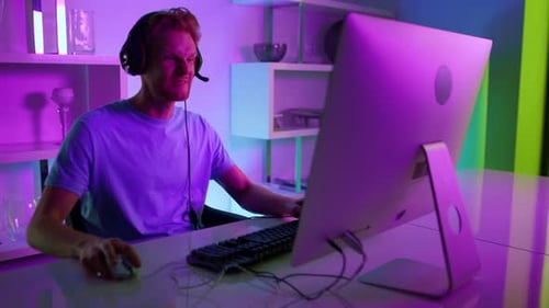 Excited Man Playing Computer Game Celebrates Victory