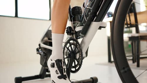 Legs of Unknown Person Pedaling on Indoor Cycle Trainer Stand