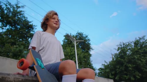 Thoughtful Skater Guy on Urban Background