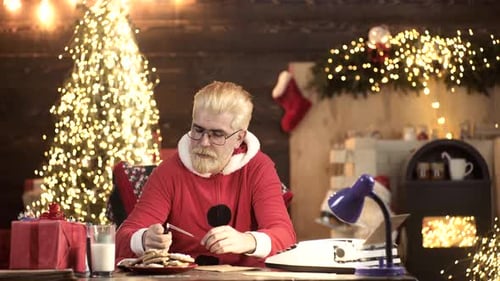 Man in Red Celebrates with Sparklers and Cookies