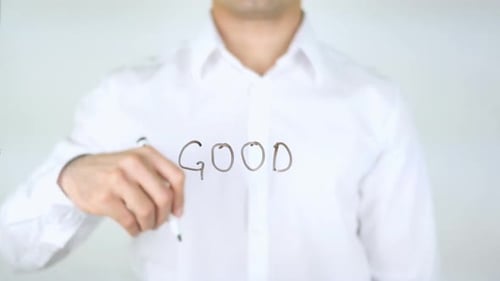 Man Writing the Word Good with a Marker