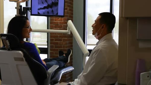 Male dentist interacting with patient 4k