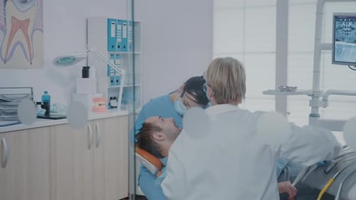 Dentist Attending to Male Patient in Clinic
