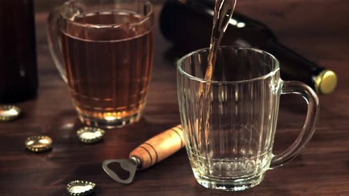 Beer Pouring Into Glass Mug on Table