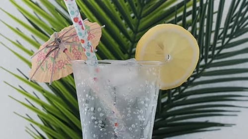 Refreshing Tropical Drink with Lemon and Umbrella
