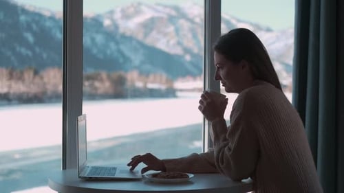Woman Working on Laptop with Mountain View