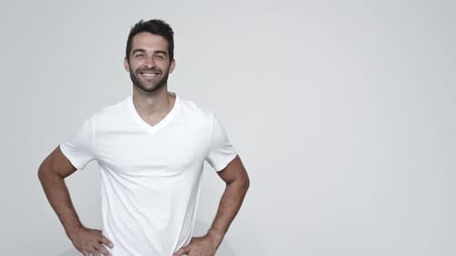 Man Smiling in White T-Shirt Turns to Camera