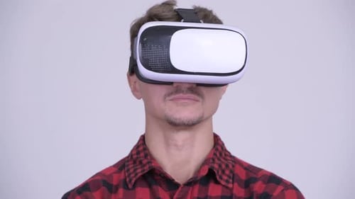 Man Wearing Virtual Reality Headset in White Room