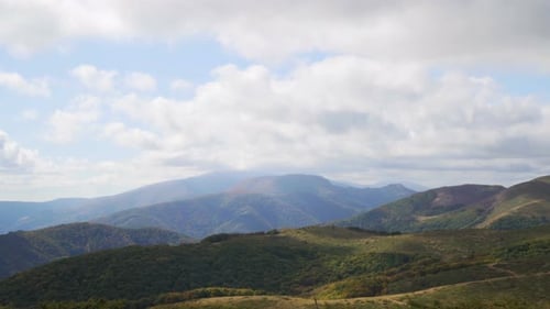 Green Mountains. Cloudy Sky and Hills Meadow. Panning. Beautiful Panoramic View