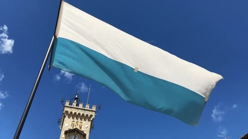 Waving Flag With Building in the Background