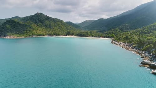 Blue Sea Ocean Waters Near Green Palm Tree Jungle Forest on Tropical Asian Island