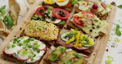 Gourmet Open Sandwiches on Cutting Board