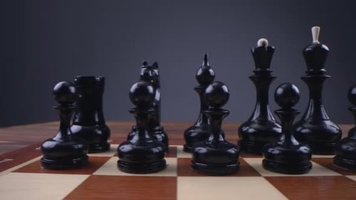 Black Chess Pieces on Wooden Chessboard