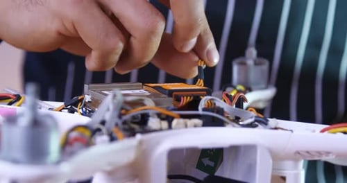 Männliche Hände reparieren eine Drohne