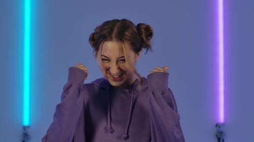 Excited Young Woman with Space Buns Smiles
