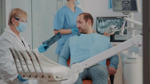 Man Talking to Dentist About X-ray in Office